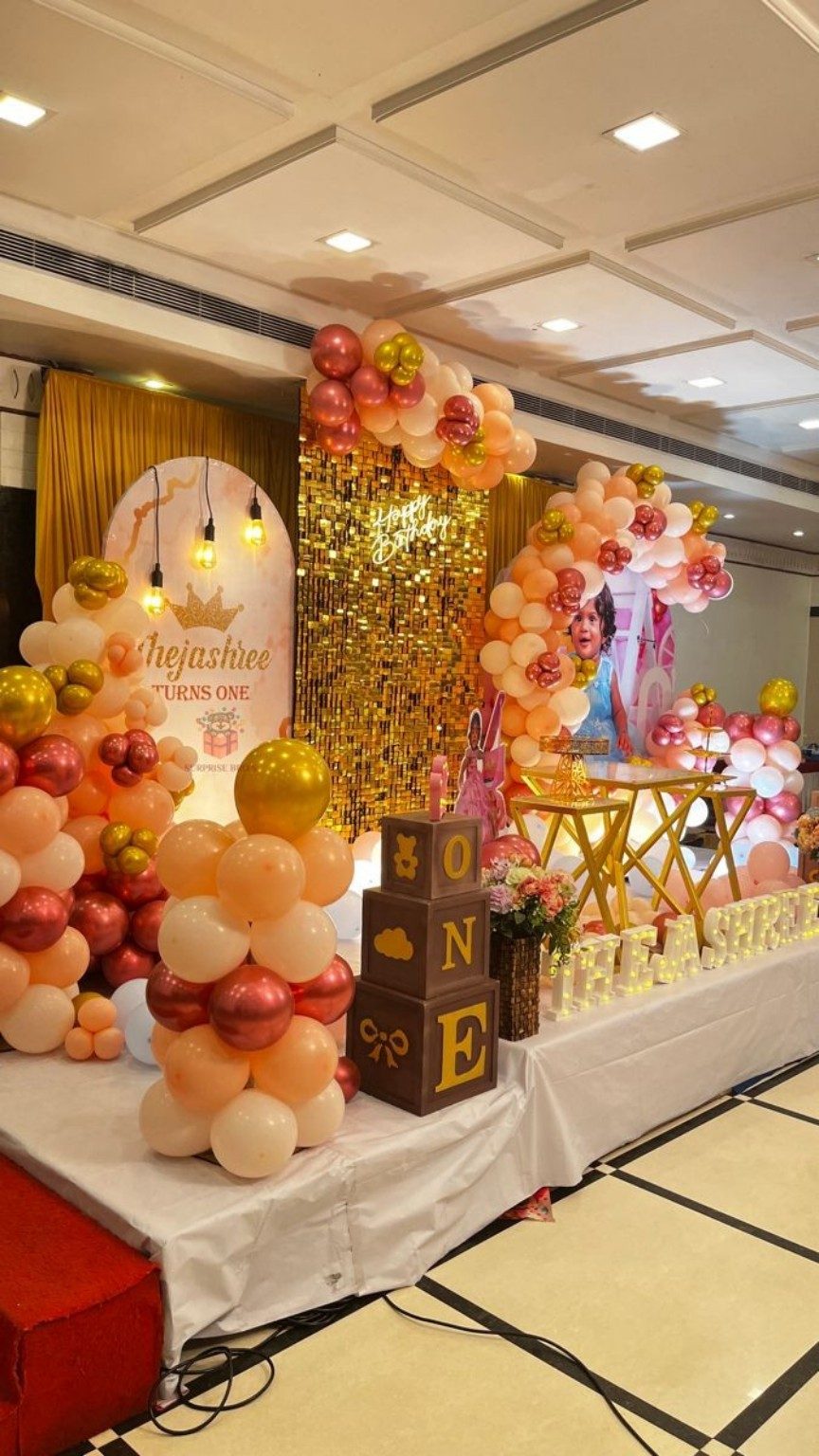 Premium gold balloon birthday decoration with illuminated backdrop