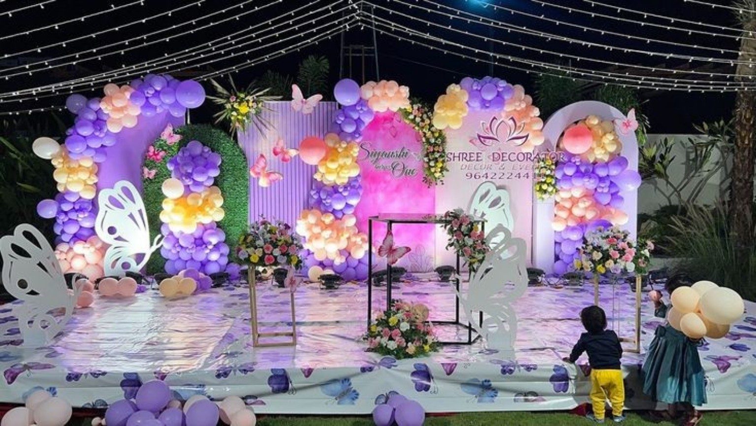 Purple and pink butterfly themed birthday stage decoration